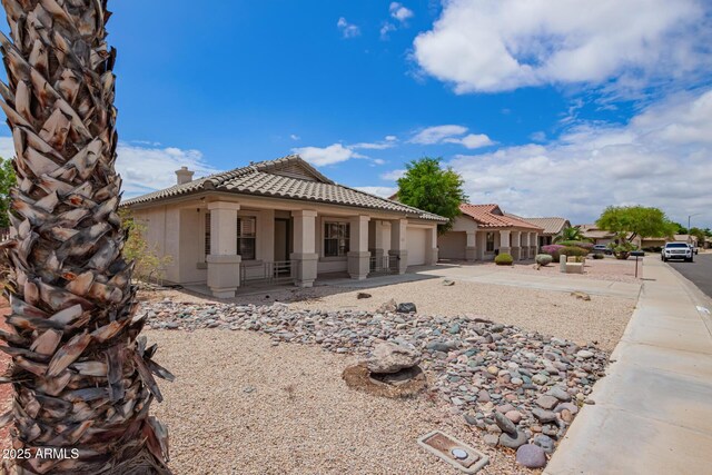 10001 W Potter Dr, Peoria, AZ 85382 - view of front of property with covered porch, a garage, stucco siding, concrete driveway, and a tile roof