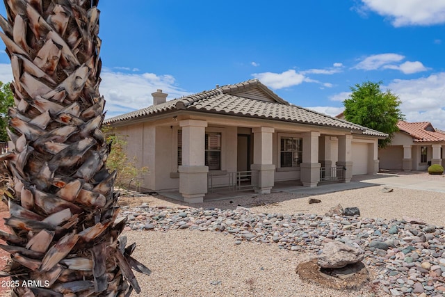 10001 W Potter Dr, Peoria, AZ 85382 - view of side of property featuring a porch, a tiled roof, a chimney, and stucco siding