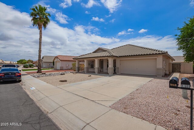 10001 W Potter Dr, Peoria, AZ 85382 - mediterranean / spanish home with a garage, stucco siding, driveway, and a tiled roof