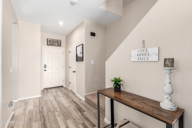 entrance foyer featuring light wood-style flooring and baseboards