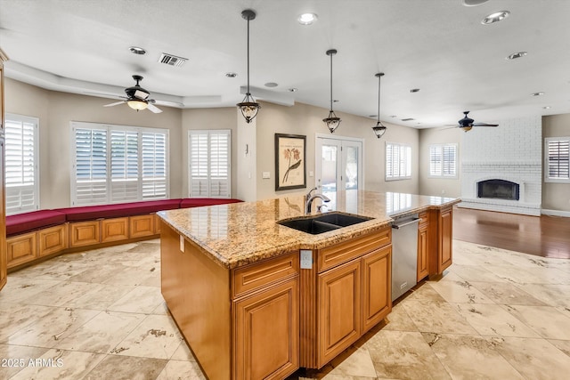 kitchen featuring ceiling fan, a sink, stainless steel dishwasher, open floor plan, and recessed lighting
