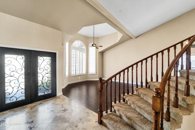 foyer featuring french doors, stairway, plenty of natural light, and ceiling fan