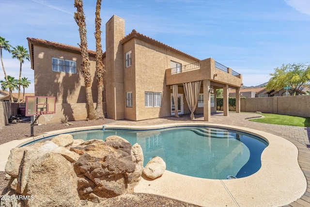 view of swimming pool with a fenced backyard and a patio area