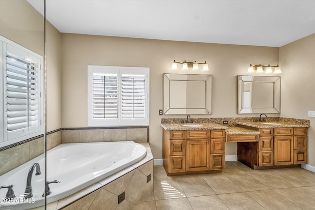 bathroom with tile patterned flooring, a jetted tub, and double vanity