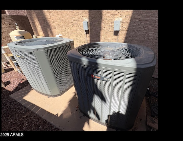 exterior view of cooling unit and stucco siding