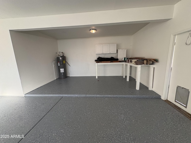 garage featuring water heater and baseboards