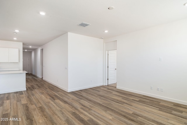 spare room with dark hardwood / wood-style flooring