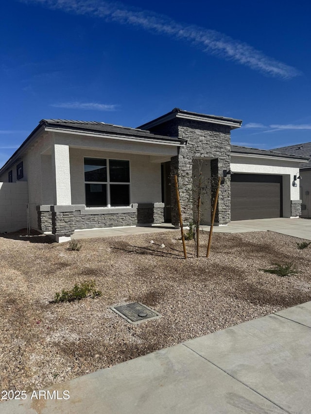 prairie-style home featuring a garage