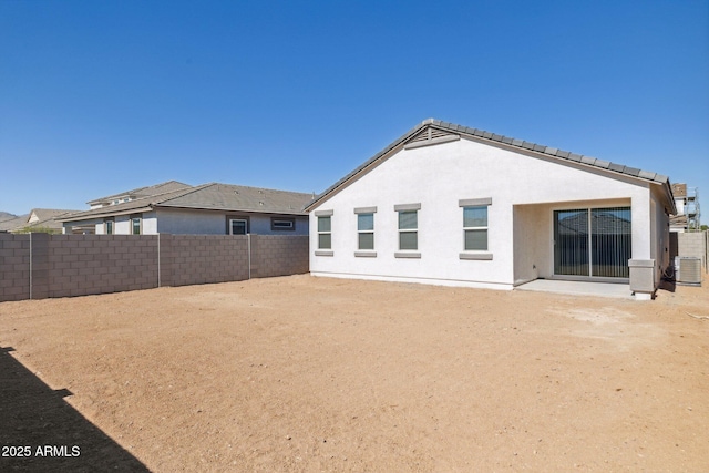 back of house with central AC unit