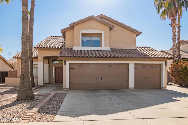 mediterranean / spanish-style home with a garage