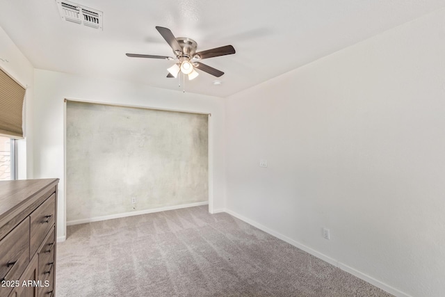 spare room featuring light colored carpet and ceiling fan