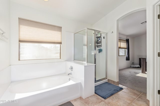 bathroom with separate shower and tub and tile patterned flooring