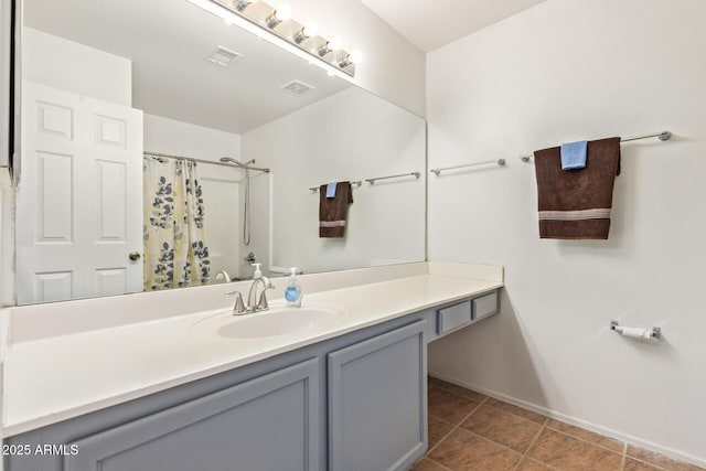 bathroom featuring vanity, tile patterned floors, and walk in shower