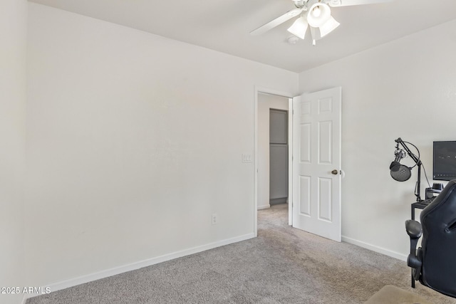 unfurnished office featuring ceiling fan and light colored carpet