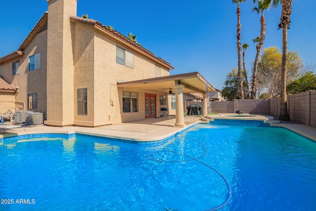 view of swimming pool featuring an in ground hot tub, central air condition unit, ceiling fan, and a patio area