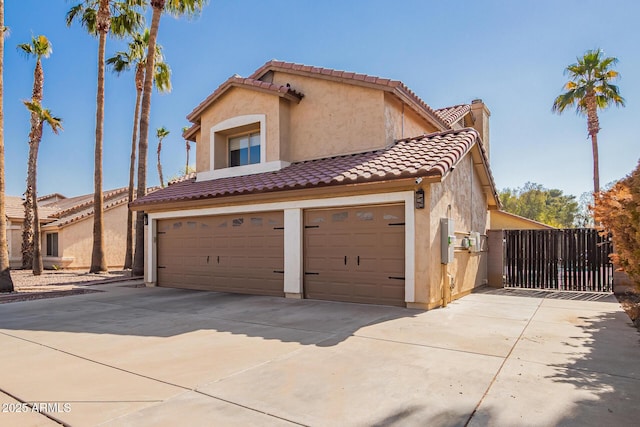 mediterranean / spanish home with a garage