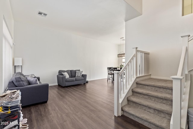 stairs featuring hardwood / wood-style floors