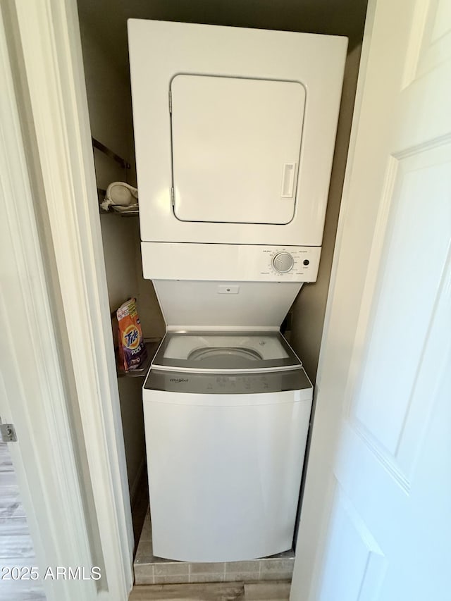 washroom featuring laundry area and stacked washer and clothes dryer