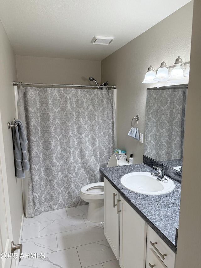 bathroom featuring toilet, vanity, visible vents, and a shower with curtain