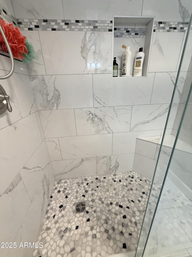 bathroom with tiled shower