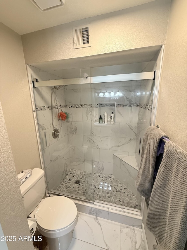 full bath with visible vents, toilet, a textured wall, marble finish floor, and a stall shower