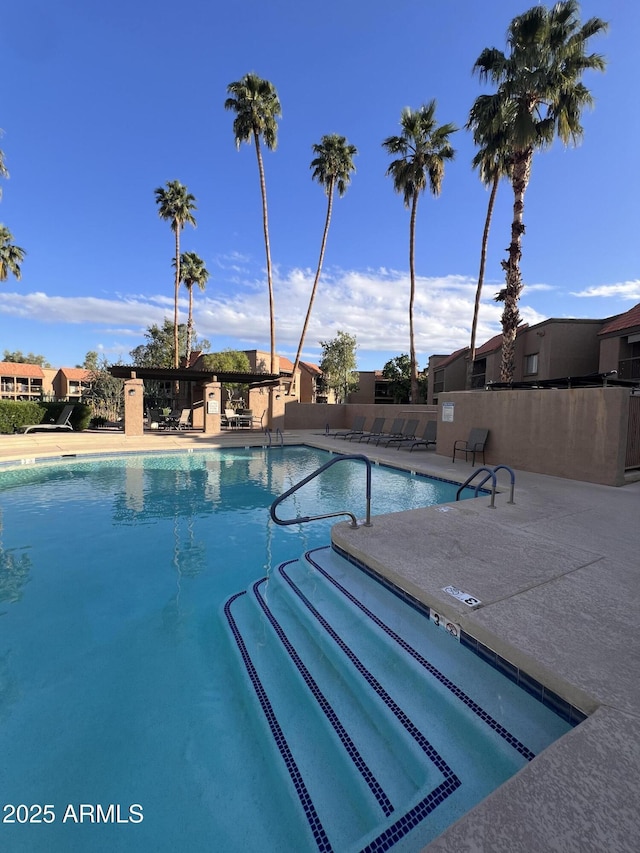 pool featuring a patio area and fence