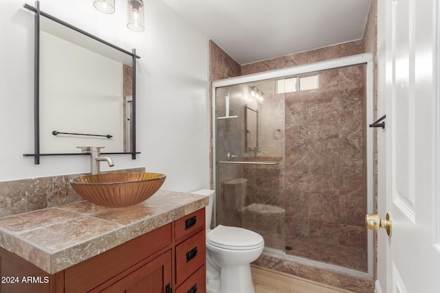 bathroom with walk in shower, toilet, vanity, and hardwood / wood-style flooring