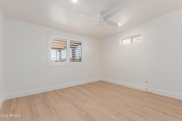 spare room with ceiling fan and light hardwood / wood-style flooring