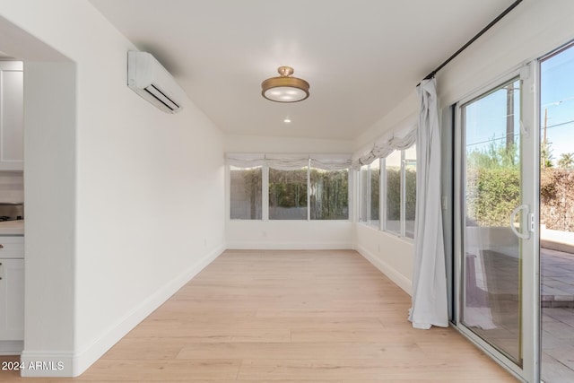 unfurnished sunroom featuring a wall unit AC