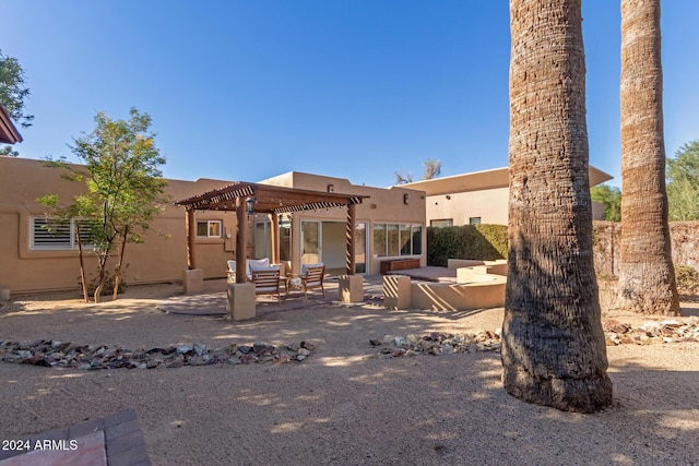 rear view of property with a pergola and a patio area