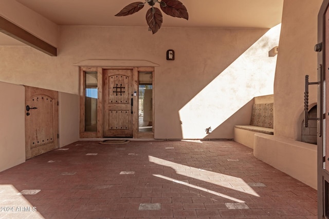 doorway to property featuring ceiling fan