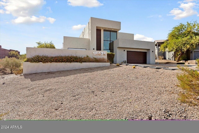 adobe home featuring a garage