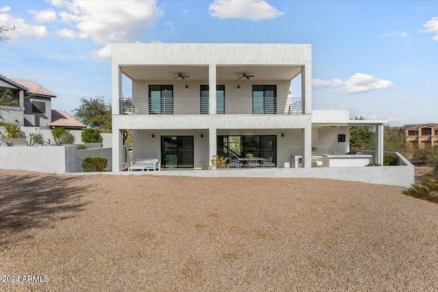 view of front facade featuring an outdoor kitchen, a patio area, and a balcony