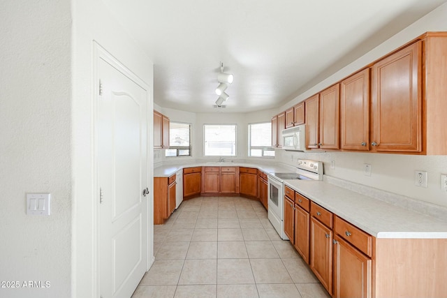 28604 N 21st Ln, Phoenix, AZ 85085 - kitchen with light tile patterned flooring, light countertops, a sink, and white appliances