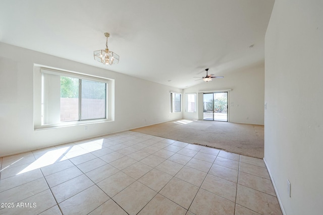 28604 N 21st Ln, Phoenix, AZ 85085 - empty room featuring light carpet, ceiling fan with notable chandelier, vaulted ceiling, and light tile patterned floors