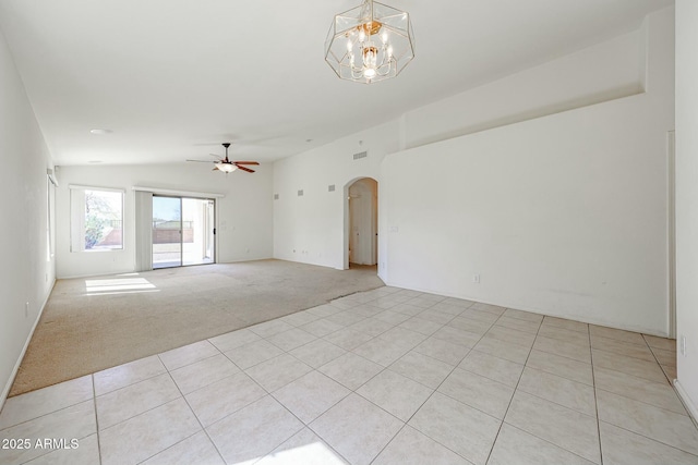28604 N 21st Ln, Phoenix, AZ 85085 - spare room with lofted ceiling, light tile patterned floors, ceiling fan with notable chandelier, arched walkways, and light carpet