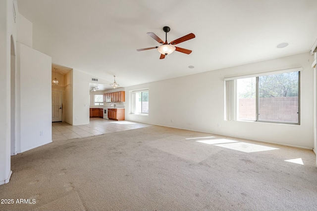 28604 N 21st Ln, Phoenix, AZ 85085 - unfurnished living room with lofted ceiling, light tile patterned floors, light colored carpet, visible vents, and ceiling fan