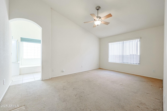 28604 N 21st Ln, Phoenix, AZ 85085 - unfurnished room with lofted ceiling, carpet flooring, baseboards, arched walkways, and a ceiling fan
