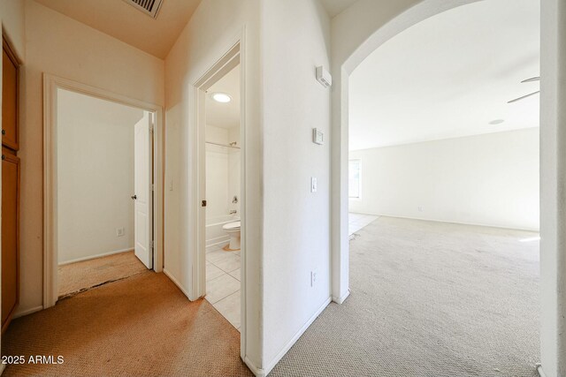 28604 N 21st Ln, Phoenix, AZ 85085 - corridor featuring arched walkways, visible vents, light tile patterned flooring, and light colored carpet