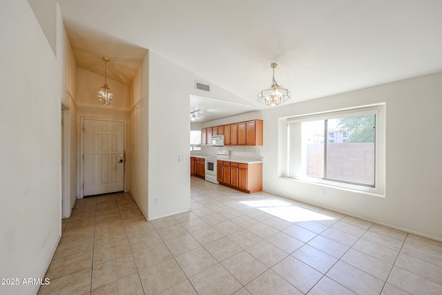 28604 N 21st Ln, Phoenix, AZ 85085 - kitchen featuring light countertops, white appliances, an inviting chandelier, light tile patterned flooring, and visible vents