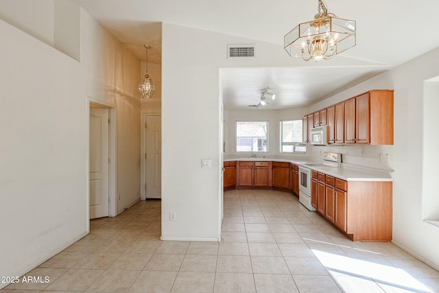 28604 N 21st Ln, Phoenix, AZ 85085 - kitchen with light tile patterned flooring, a notable chandelier, light countertops, white appliances, and visible vents