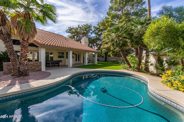 view of pool with a yard and a patio