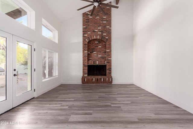 10338 E San Salvador Dr, Scottsdale, AZ 85258 - unfurnished living room with high vaulted ceiling, a ceiling fan, a fireplace, wood finished floors, and beam ceiling