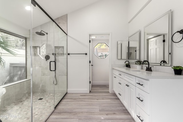 10338 E San Salvador Dr, Scottsdale, AZ 85258 - full bathroom featuring a stall shower, lofted ceiling, double vanity, baseboards, and wood finished floors
