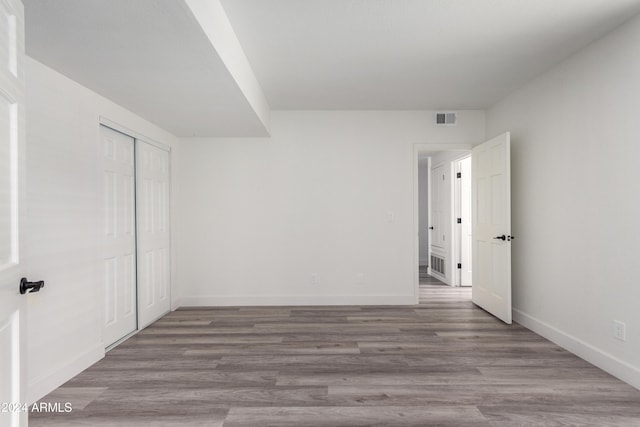 10338 E San Salvador Dr, Scottsdale, AZ 85258 - unfurnished bedroom featuring baseboards, a closet, and wood finished floors