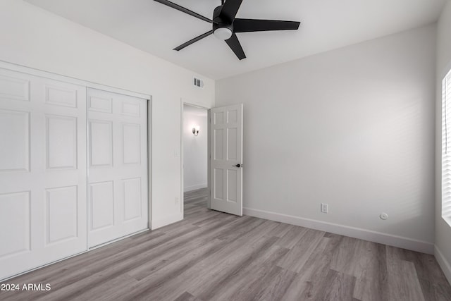 10338 E San Salvador Dr, Scottsdale, AZ 85258 - unfurnished bedroom with light wood-style flooring, a closet, baseboards, and ceiling fan