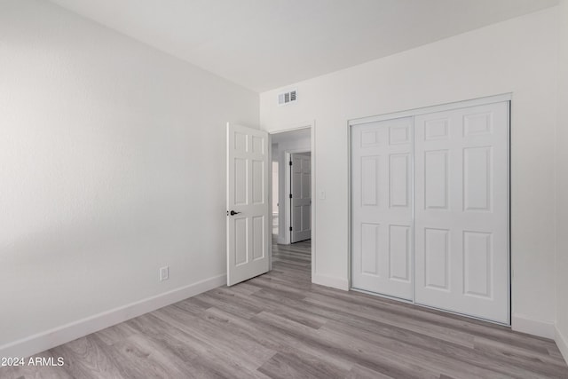 10338 E San Salvador Dr, Scottsdale, AZ 85258 - unfurnished bedroom with wood finished floors, baseboards, and a closet
