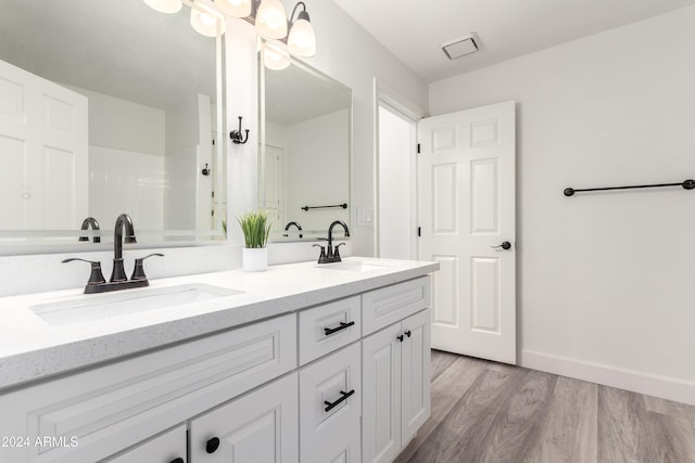 10338 E San Salvador Dr, Scottsdale, AZ 85258 - full bathroom featuring wood finished floors, double vanity, a shower, and baseboards