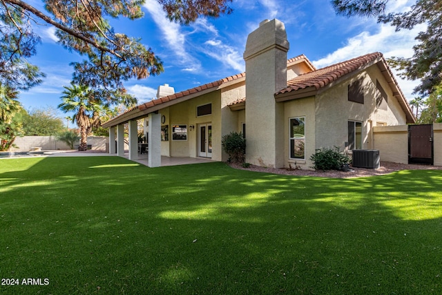 10338 E San Salvador Dr, Scottsdale, AZ 85258 - back of house with central air condition unit, a tile roof, stucco siding, a chimney, and a patio