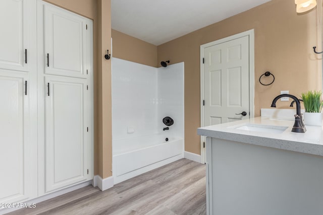 bathroom featuring vanity, shower / bath combination, and hardwood / wood-style flooring